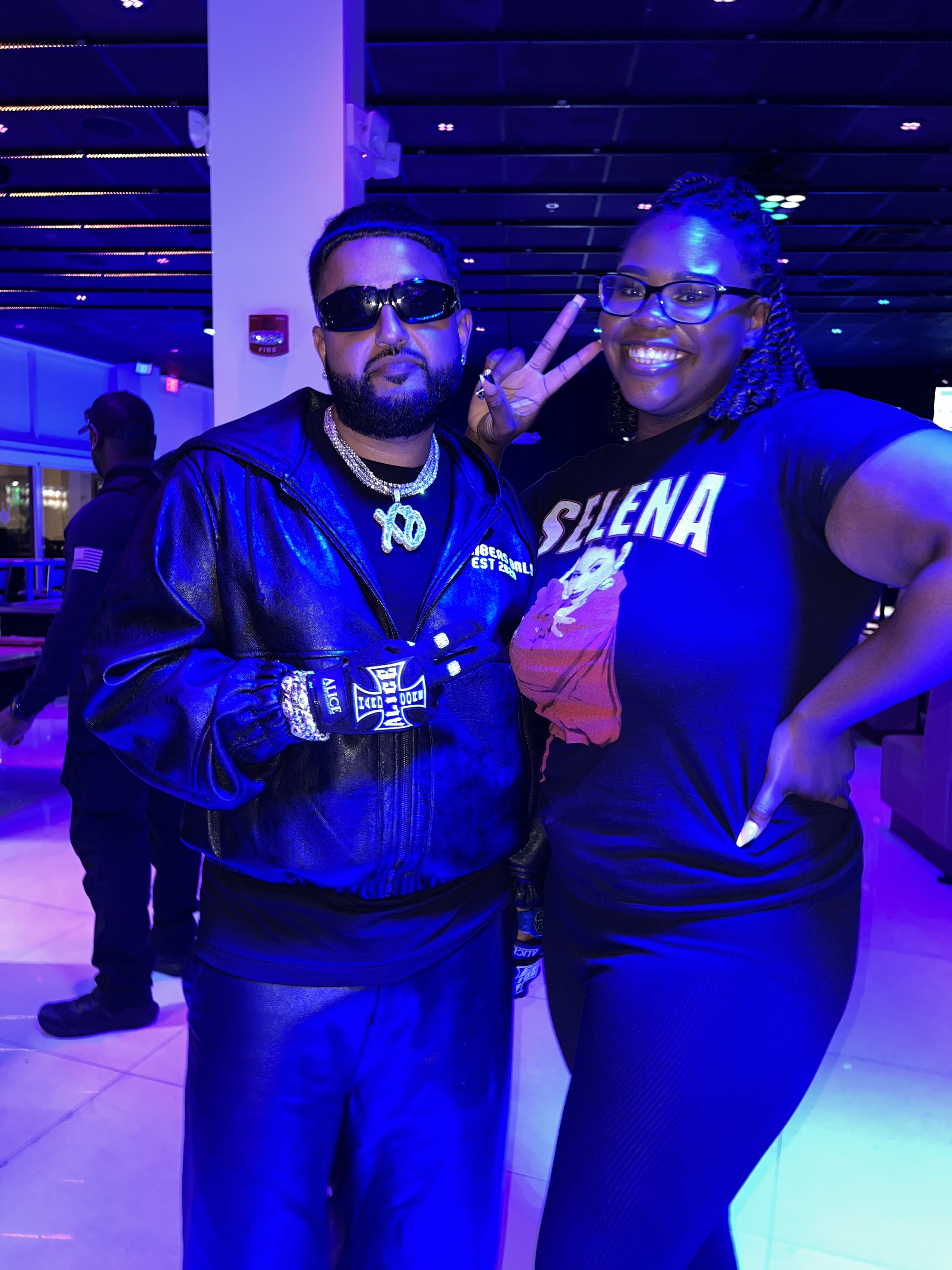 DJ Sam I Am with an artist under blue and purple club lights